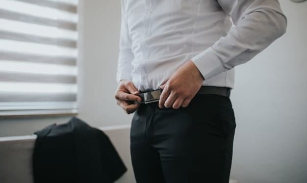 male is fastening black belt his trousers 181624 13646